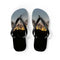 Black flip-flops with a sunset and silhouetted trees scene.
