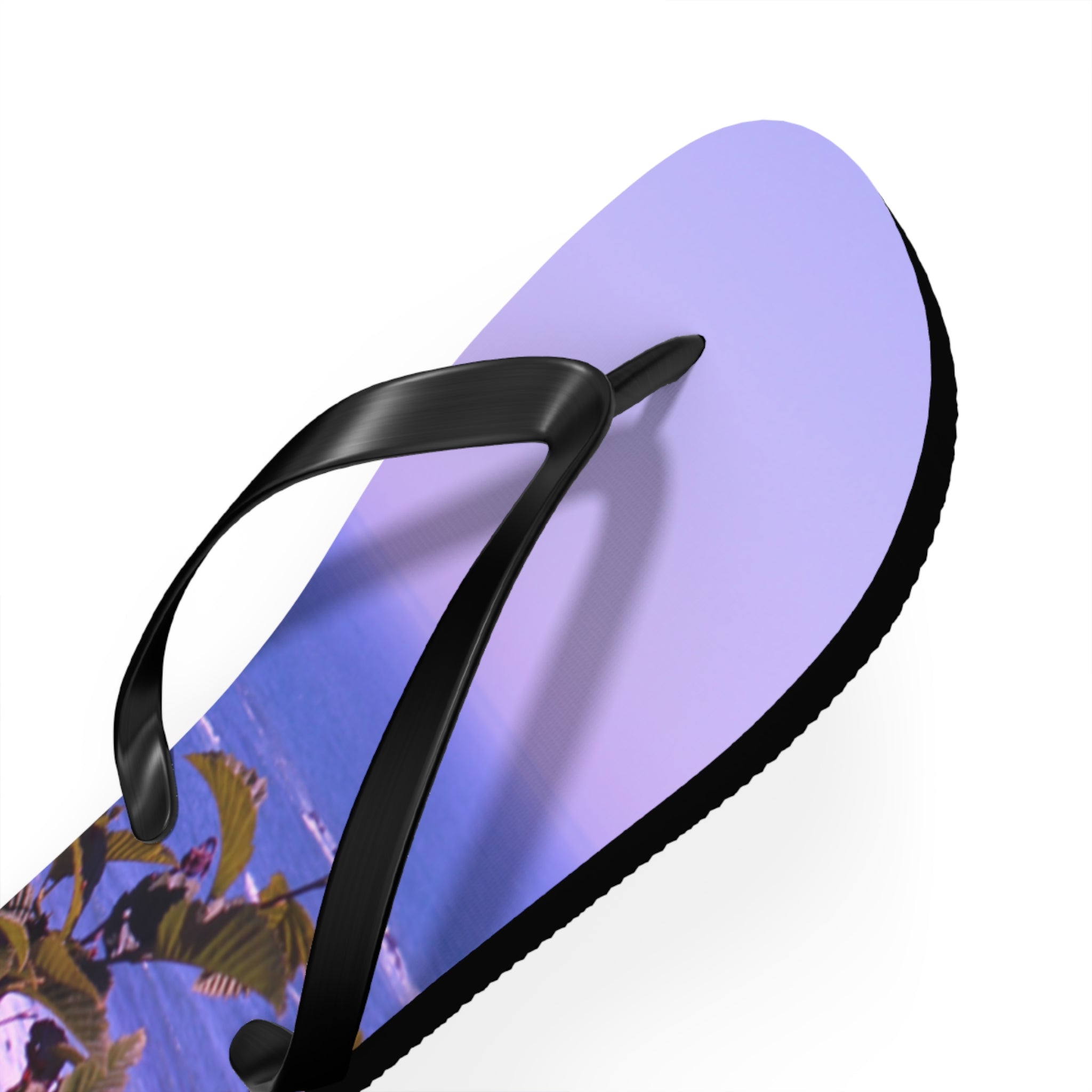 Lavender flip-flop with a beach scene on the sole and black straps.