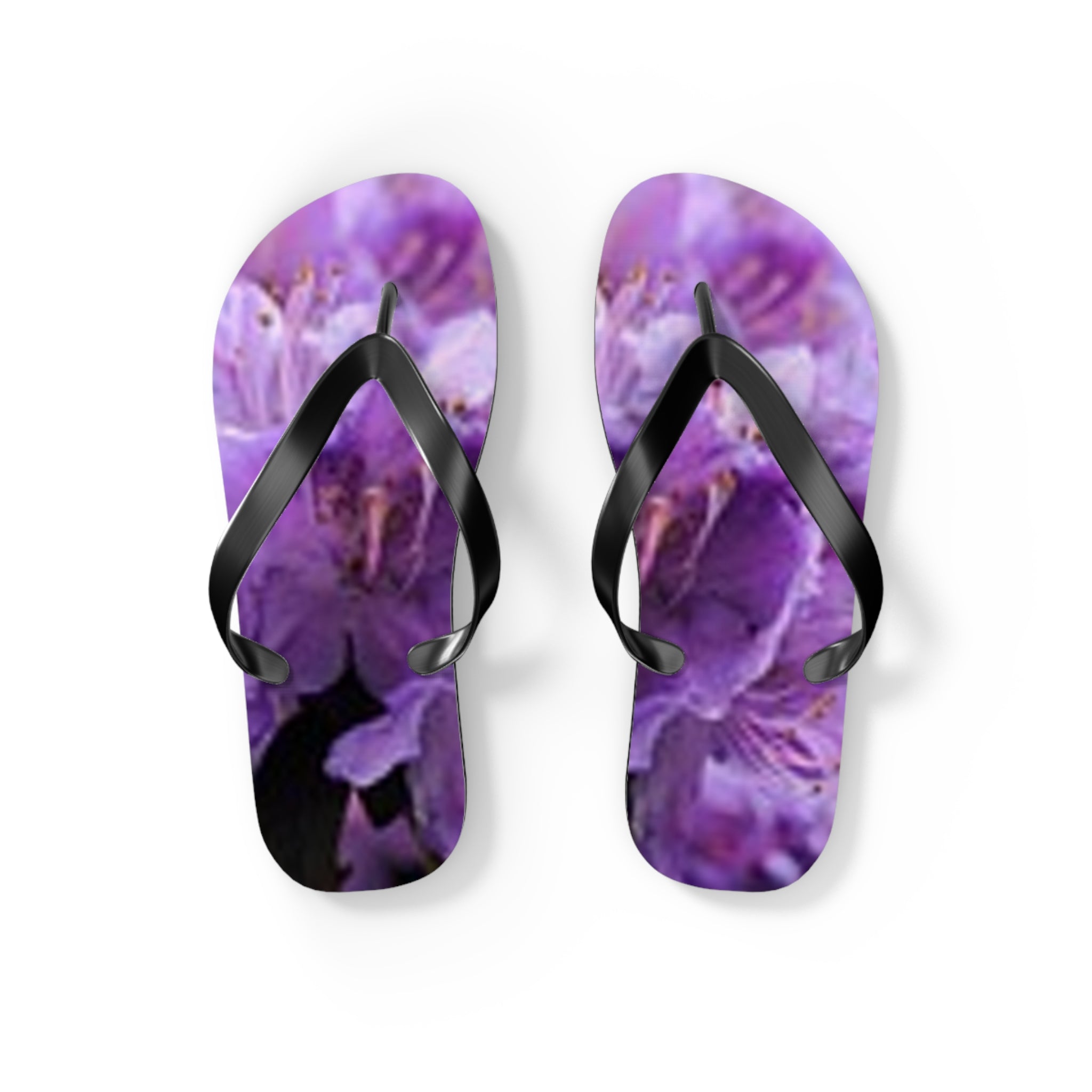 Purple floral flip-flops with black straps on a white background.
