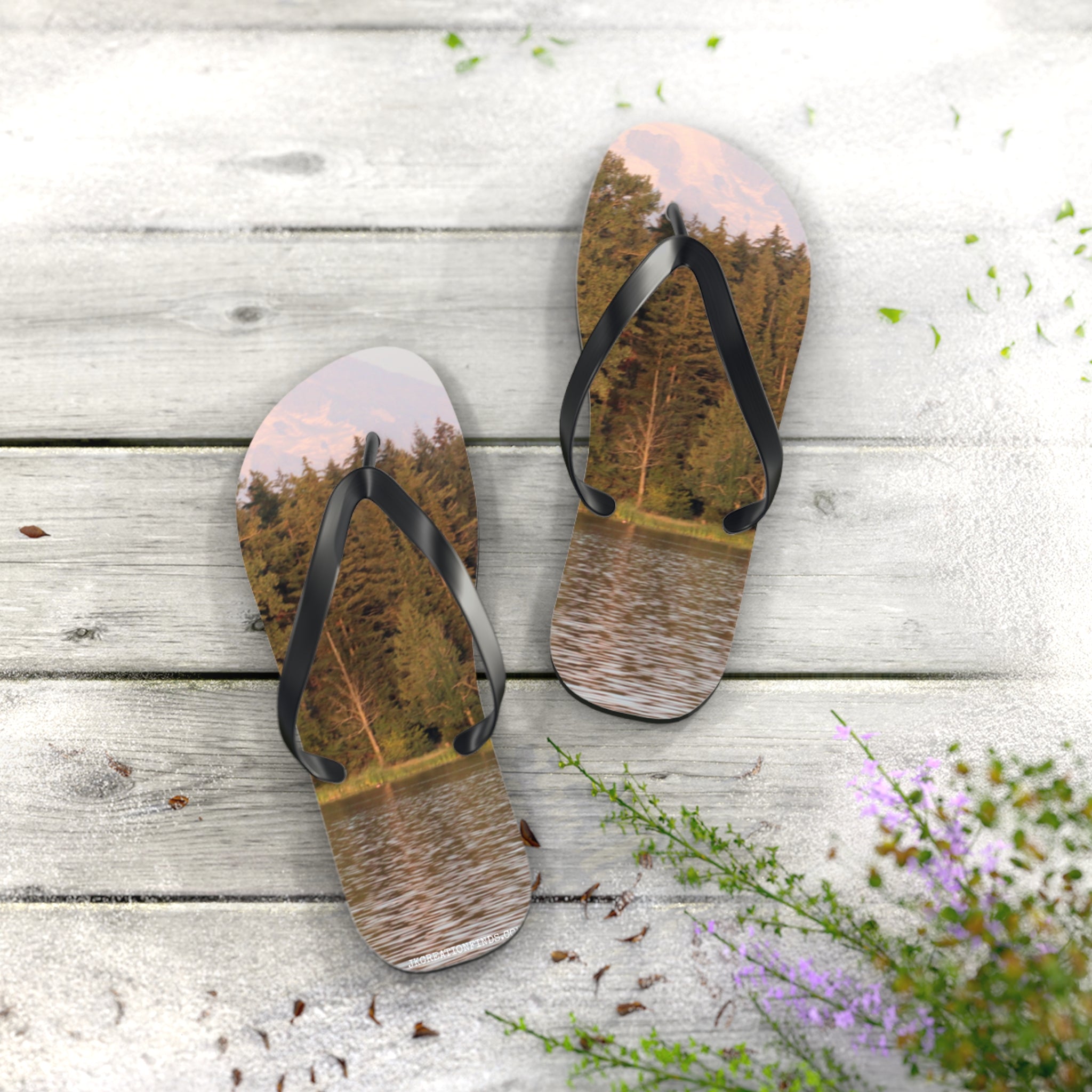 Flip-flops with a forest and lake scene printed on the soles.