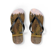 Flip-flops with a forest and mountain lake scene printed on the soles.