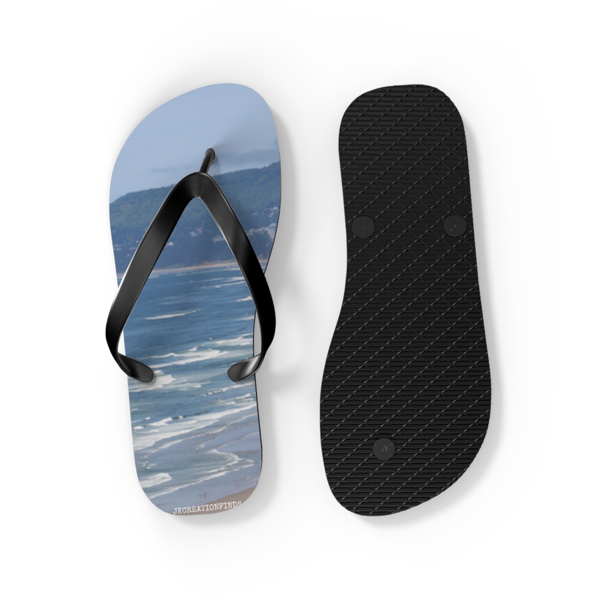 Black flip-flops with ocean view soles, one sole shown upside down.