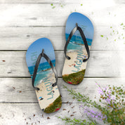 Laguna Beach flip-flops on a wooden surface with flowers.