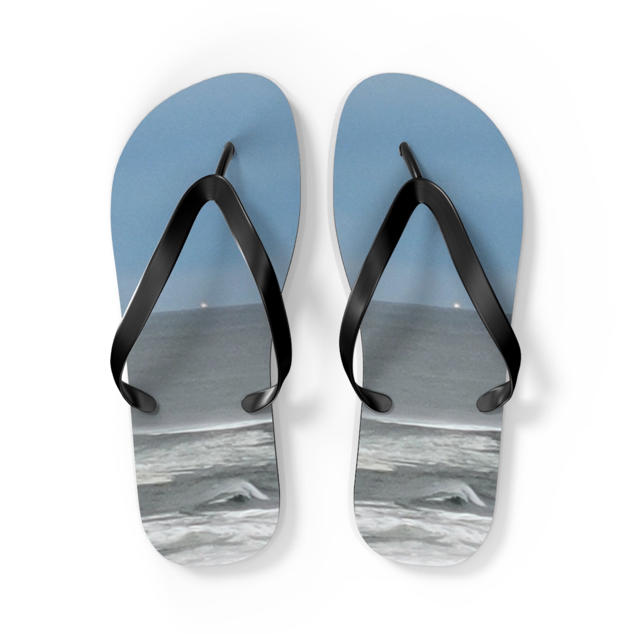 Pair of blue flip-flops with a beach scene graphic.