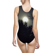 Black one-piece swimsuit with a sunlit tree silhouette pattern.