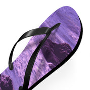 Purple flip-flop with wave and rock design.