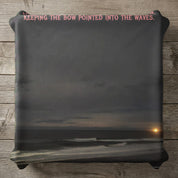Dark ocean waves at sunset, pink text above reads "KEEPING THE BOW POINTED INTO THE WAVES."