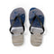 Flip-flops with a scenic landscape of people on a beach and mountains.