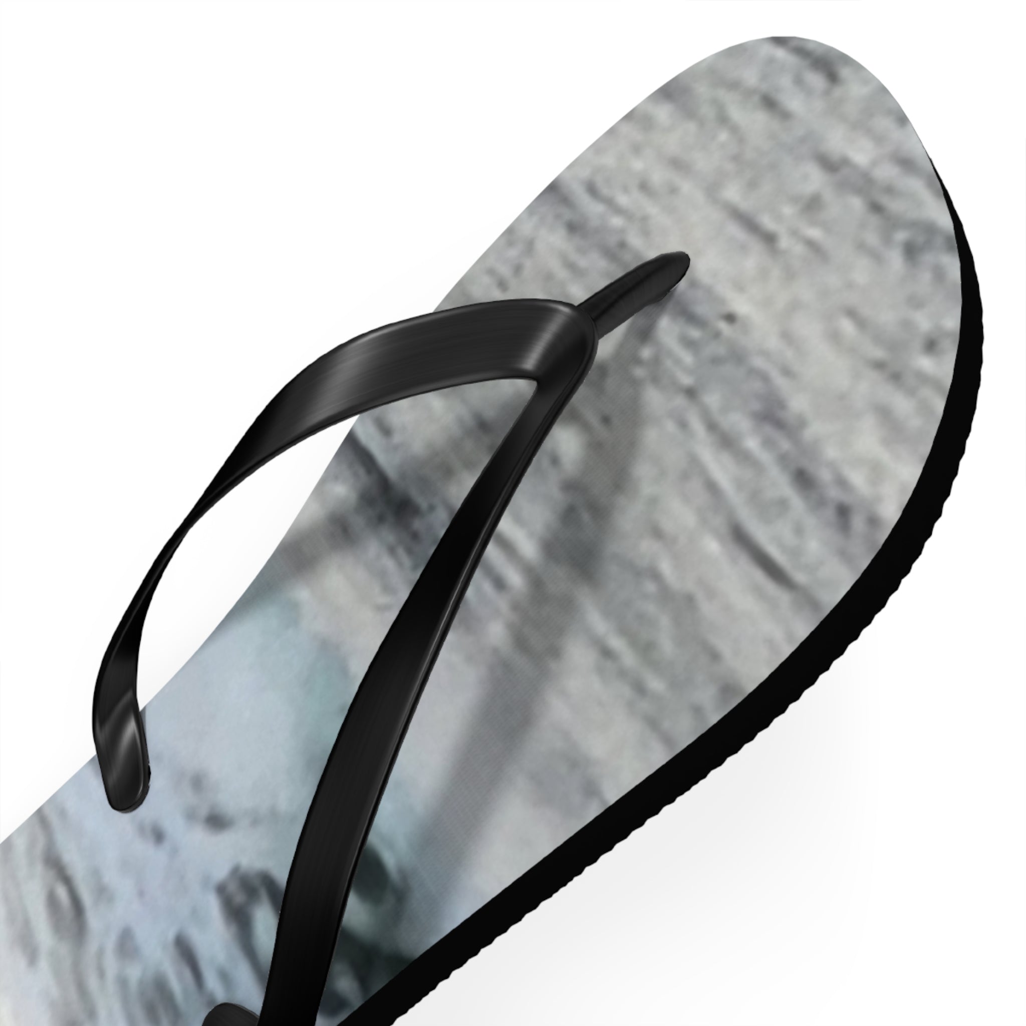 Black flip-flop sandal with a gray and white abstract pattern on the sole.