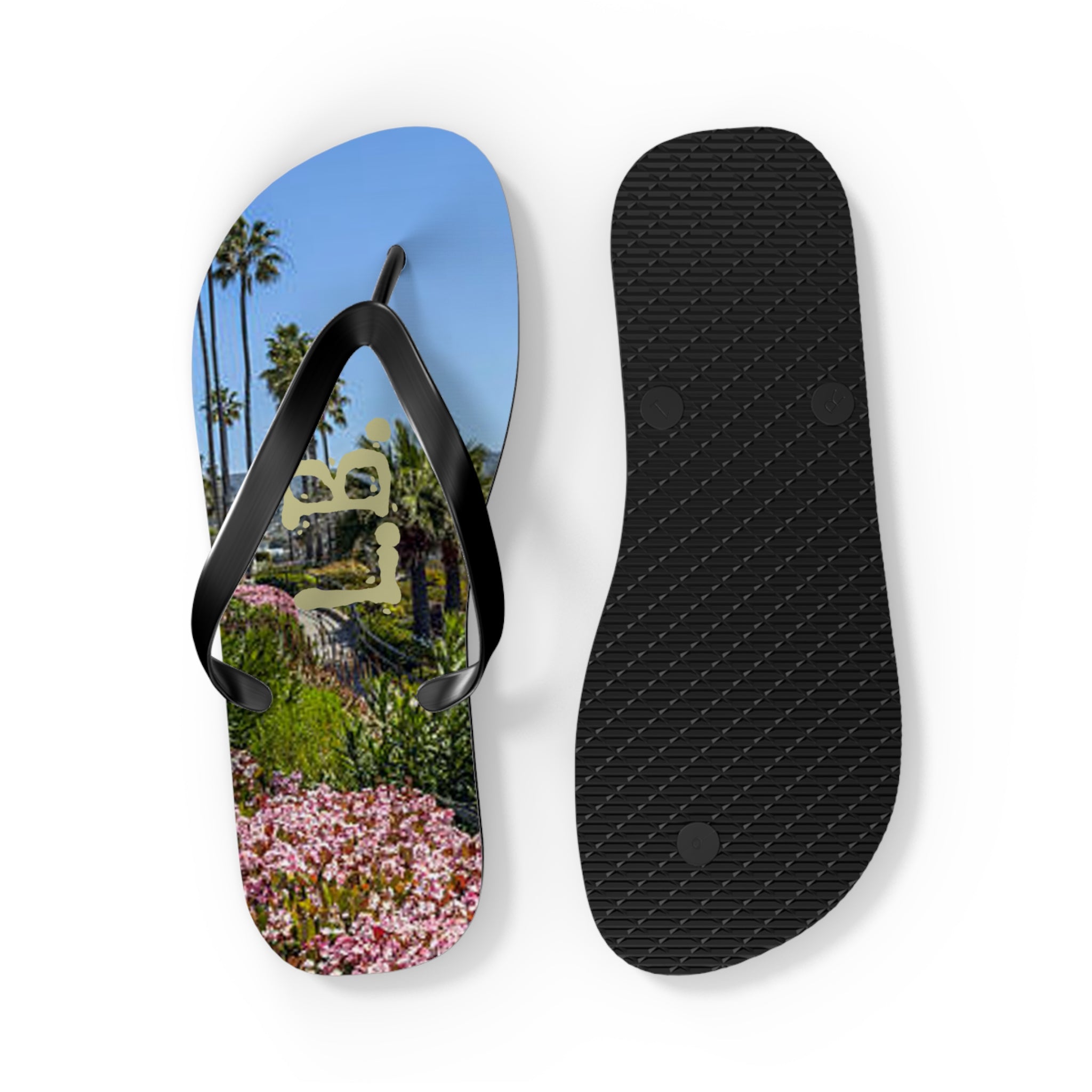 Flip-flops with a scenic view of palm trees and pink flowers.