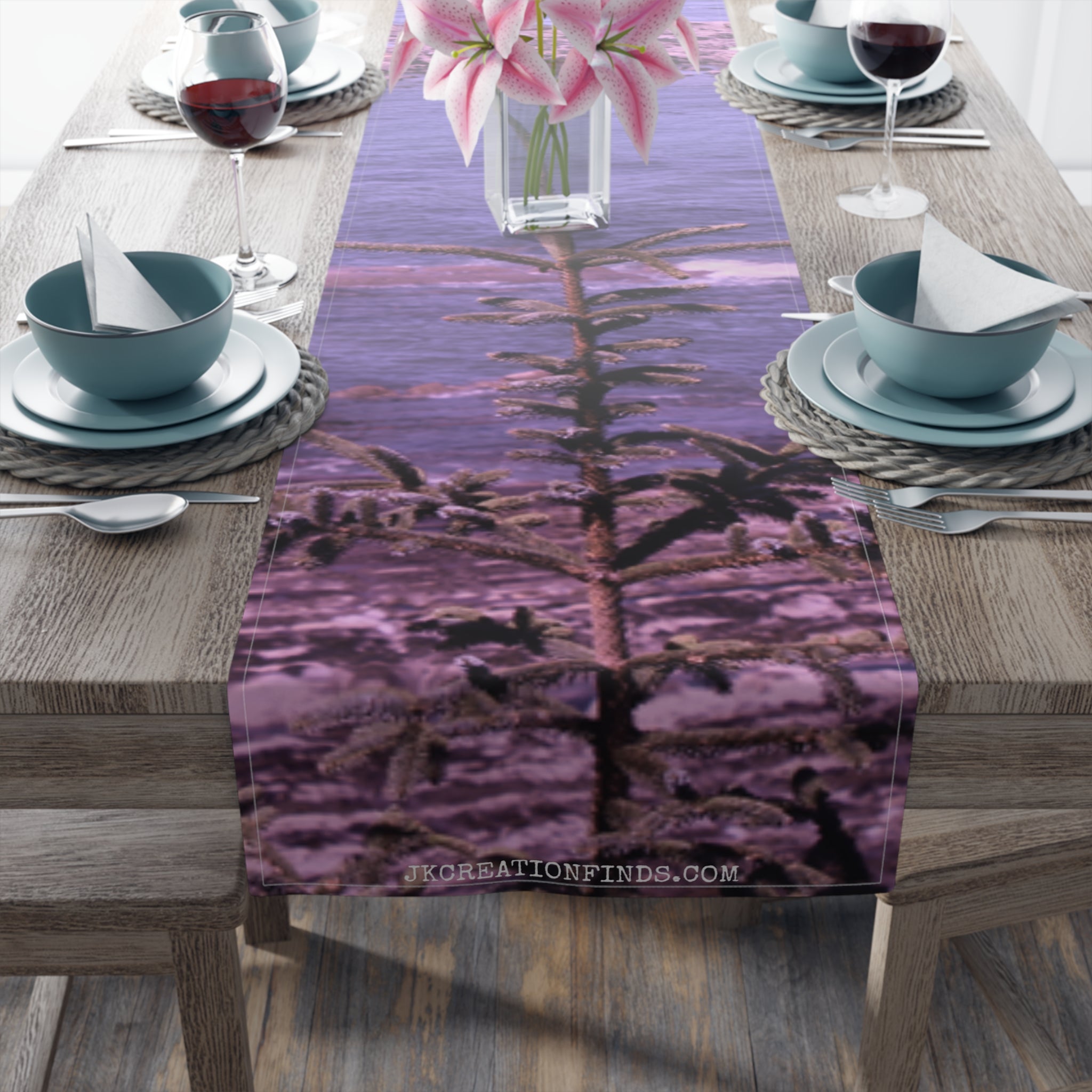 Table runner with a photograph of a fir tree against a purple sky.