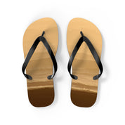 Brown flip-flops with black straps on a white background.
