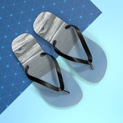 Light blue flip-flops with black straps on a blue grid background.