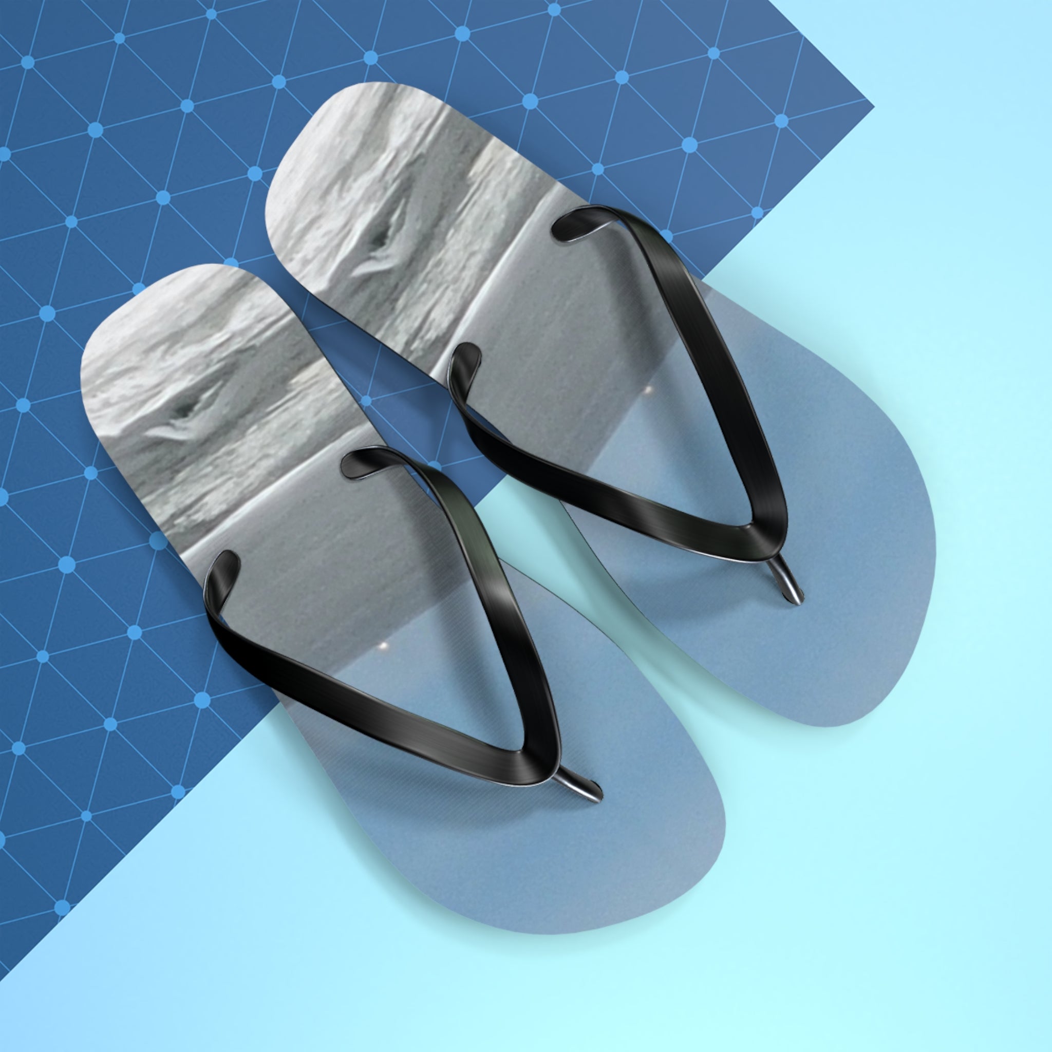 Blue flip-flops with black straps on a blue and white background.