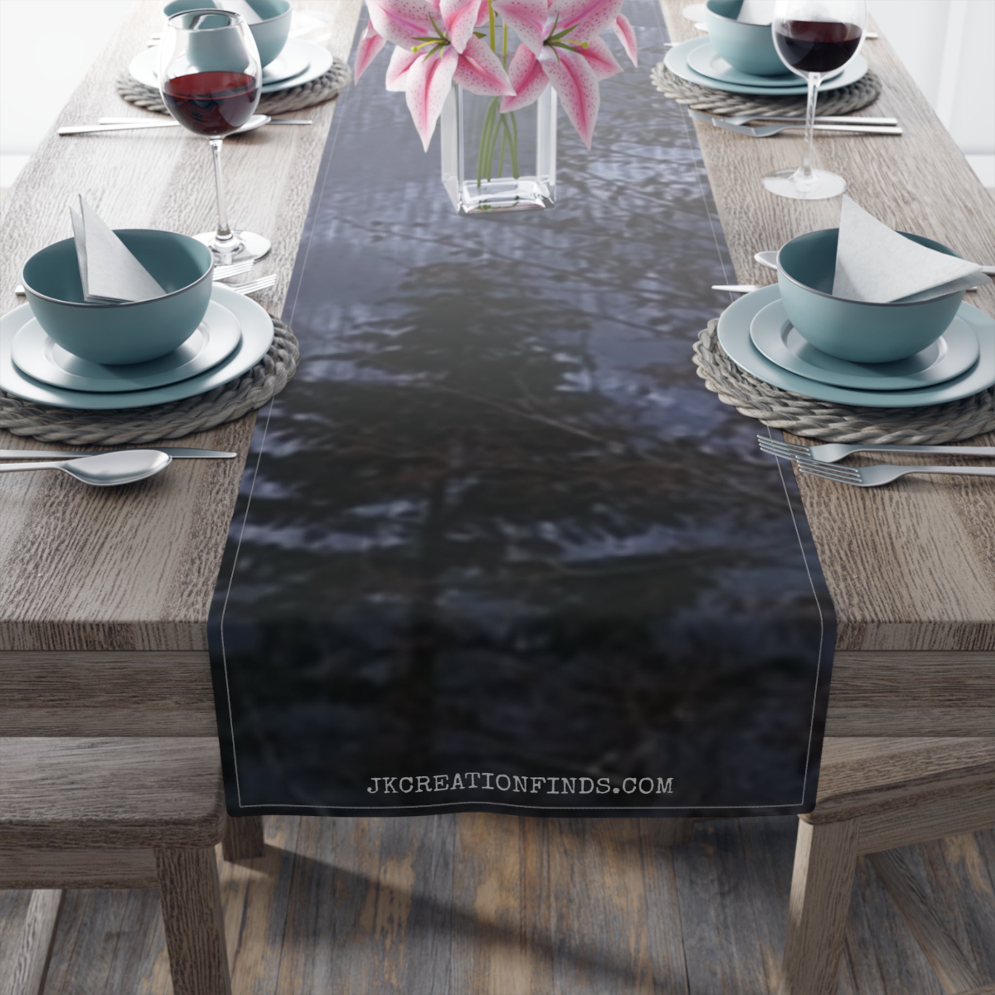 Dark forest scene printed on a fabric table runner with white text.