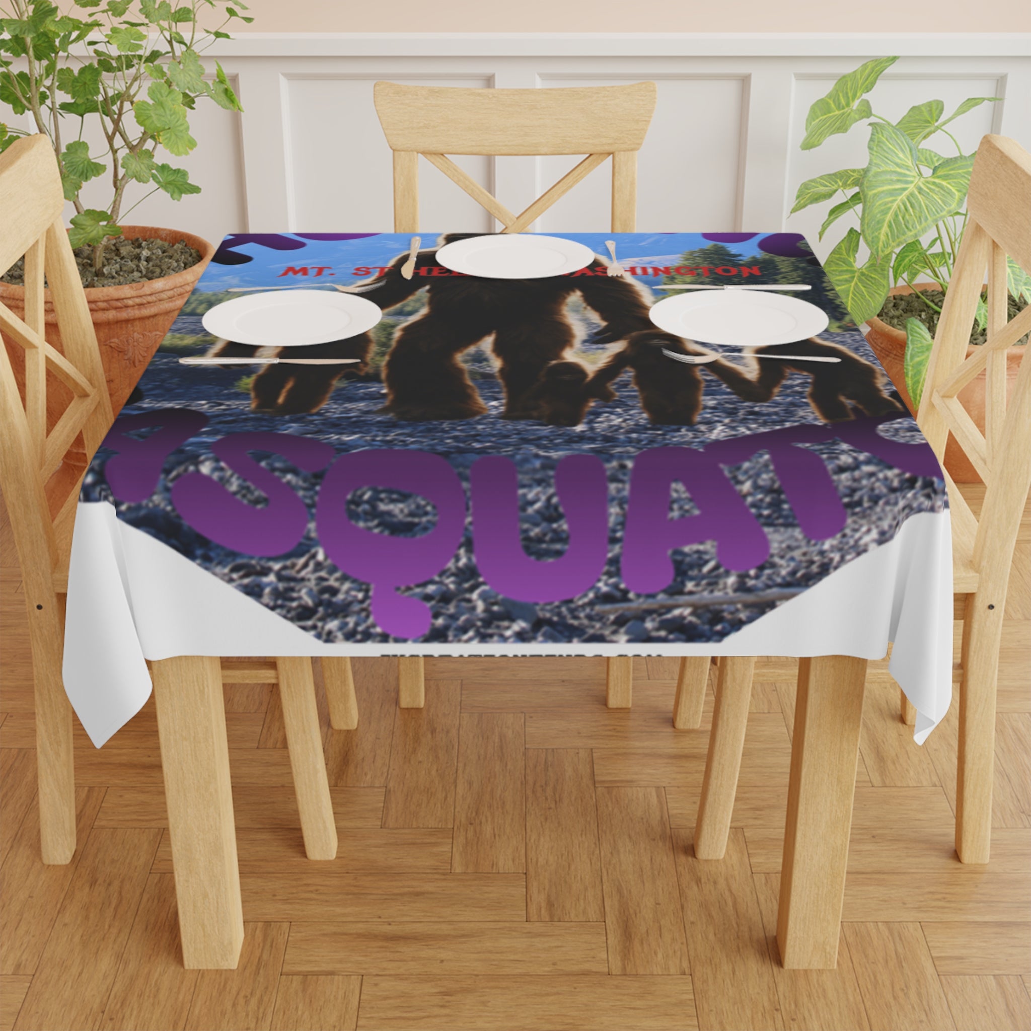 Tablecloth with purple "Squad" text and bear graphic on a wooden table.