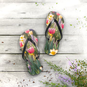 Pink tulip and purple flower flip-flops on a weathered wooden surface.