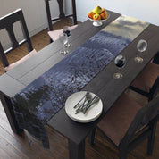 Dark wooden dining table with abstract blue and grey nature scene runner.