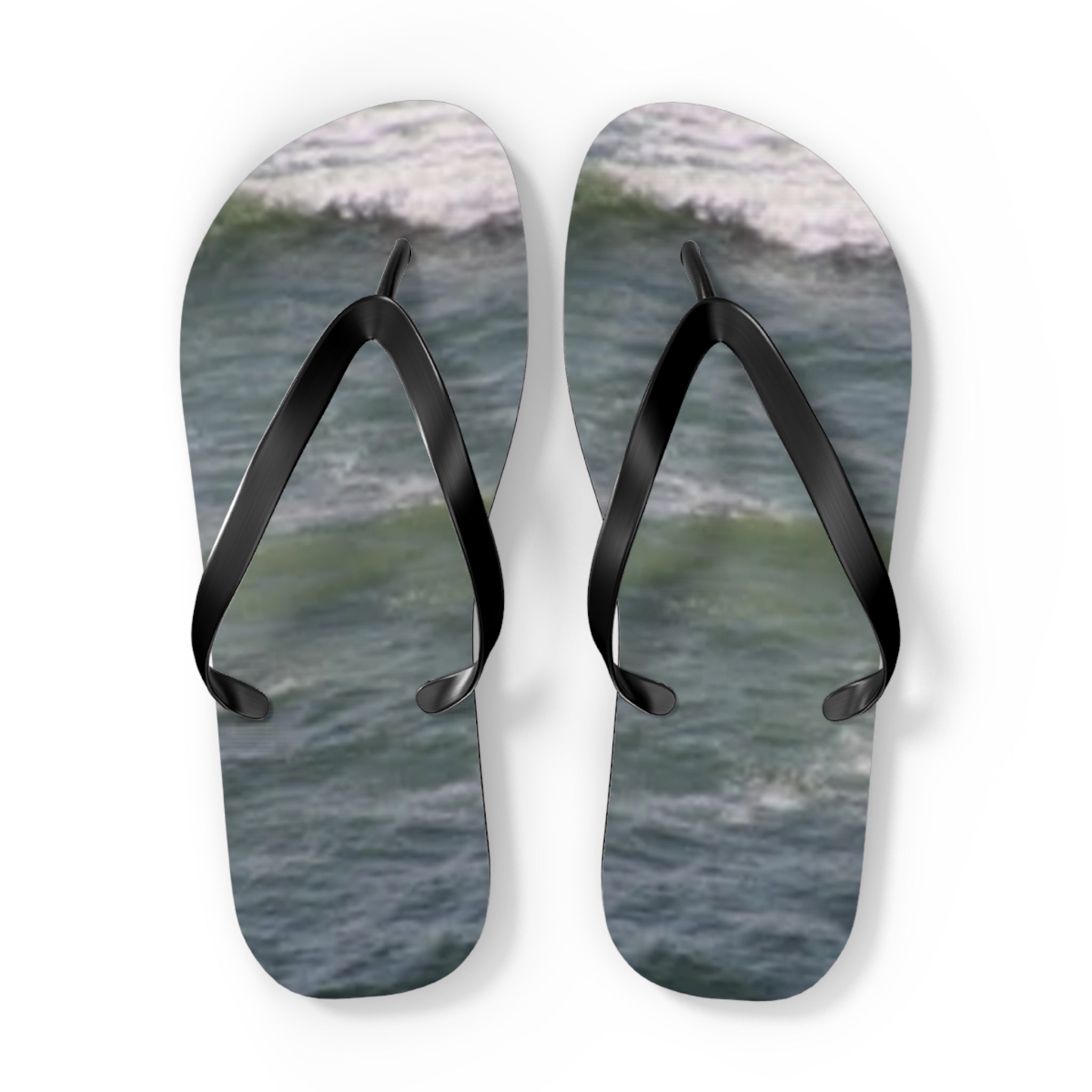 Black flip-flops on a background of ocean waves.