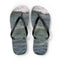 Black flip-flops on a background of ocean waves.