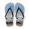 Flip-flops with beach scene showing two small figures and ocean waves.