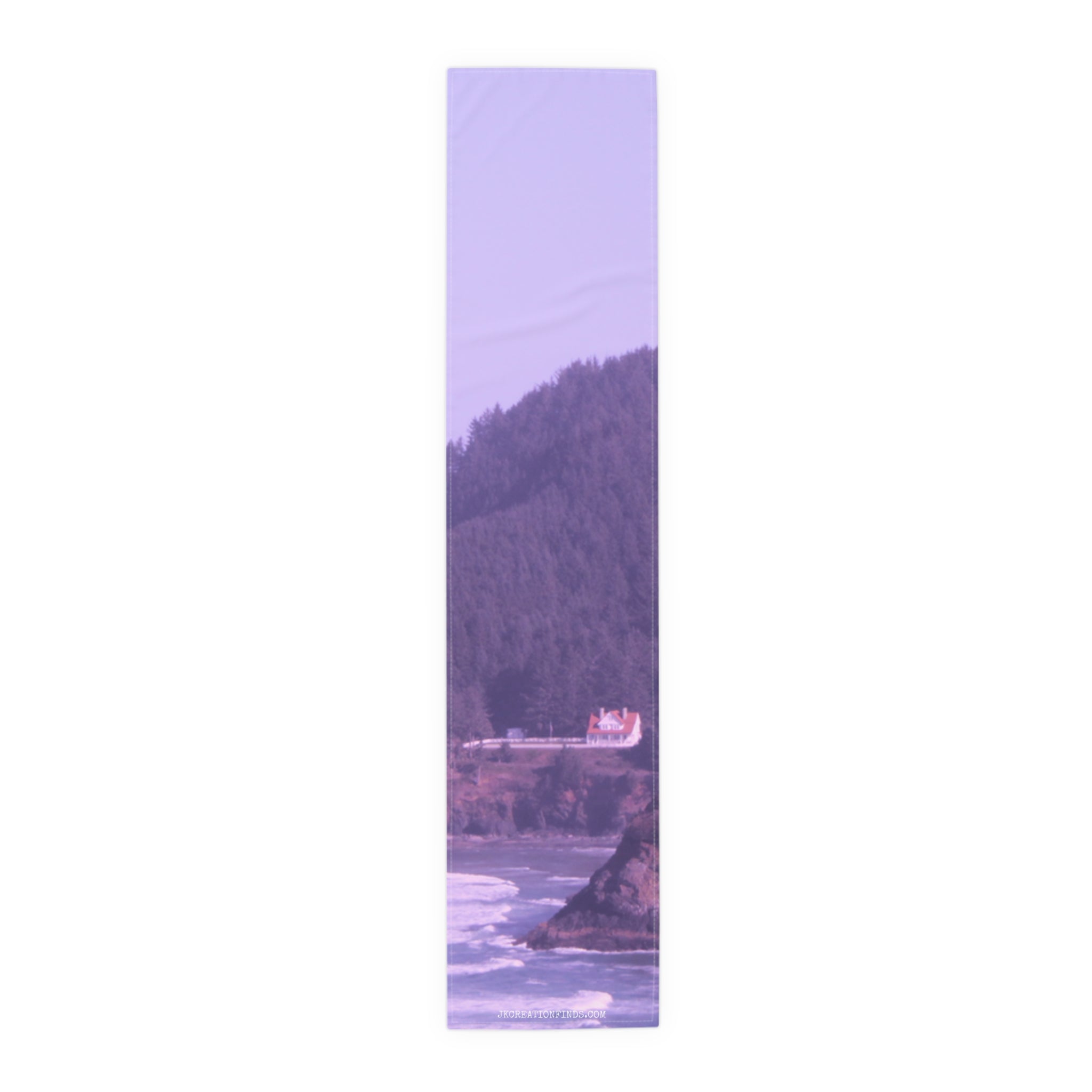 White house on a cliff overlooking a rocky shore and ocean.