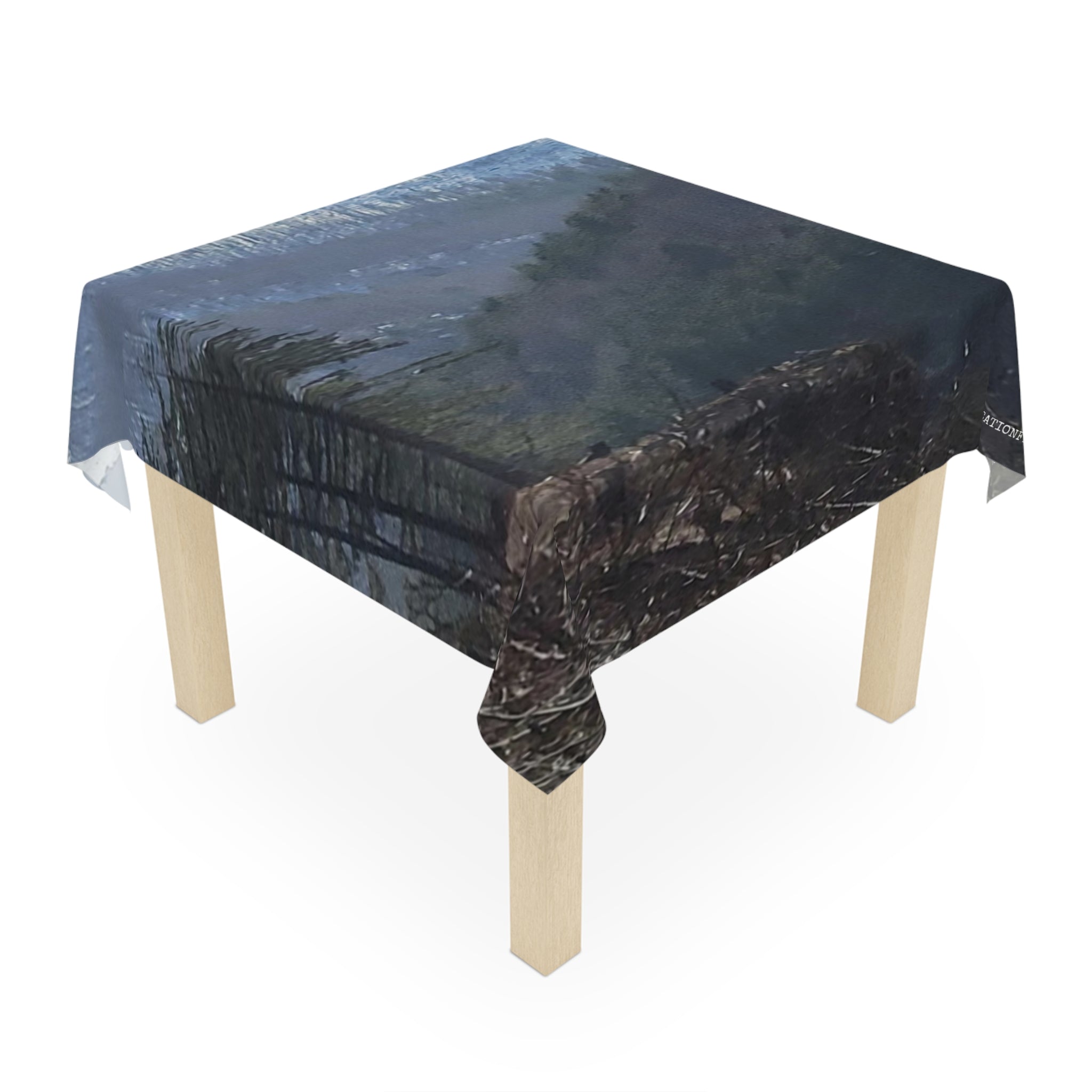 Tablecloth with a forest stream reflection scene.