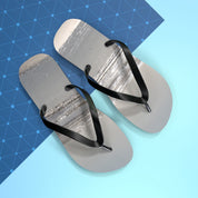 Gray flip-flops with black straps on a blue background with a network pattern.