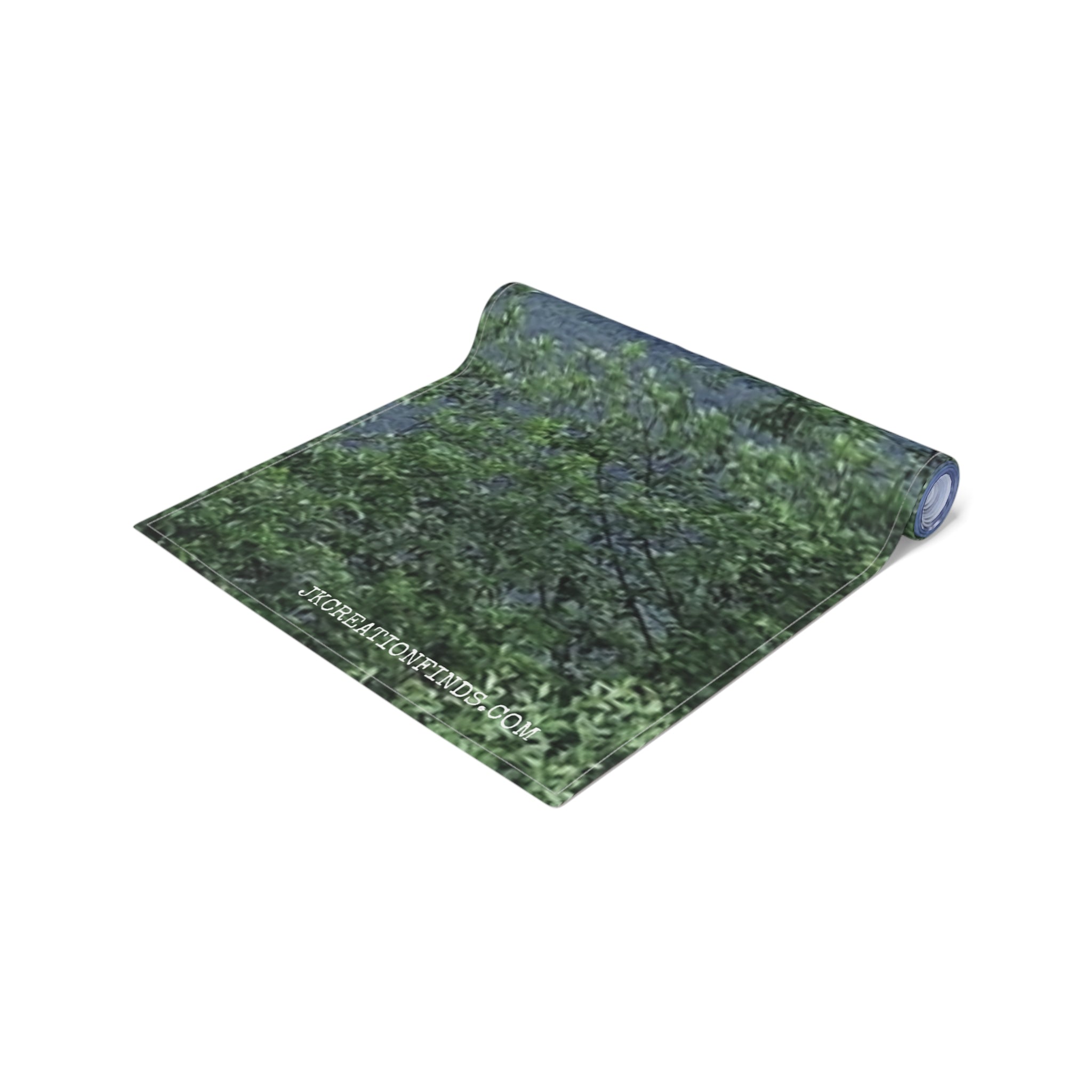 Rolled yoga mat with green leafy pattern and "JKCREATIONFINDS.COM" text.