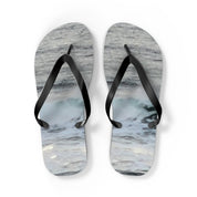 White flip-flops with a wave pattern and black straps.
