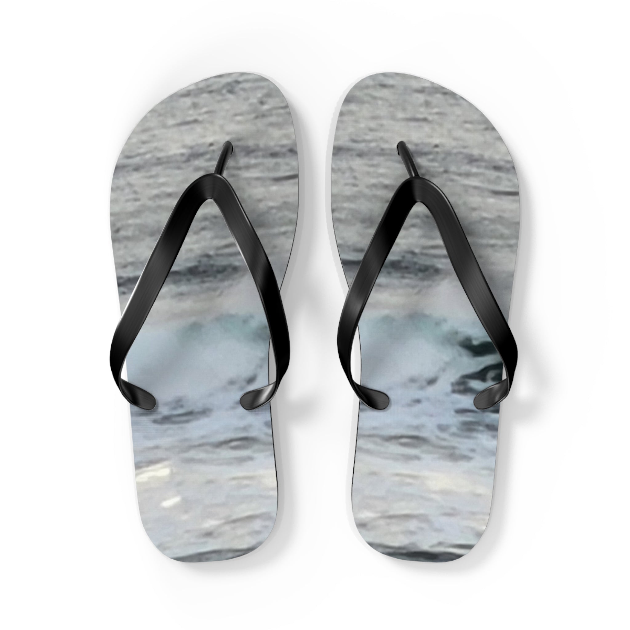 White flip-flops with a wave pattern and black straps.