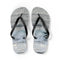 White flip-flops with a wave pattern and black straps.