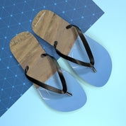 Flip-flops with a landscape design on a blue geometric background.