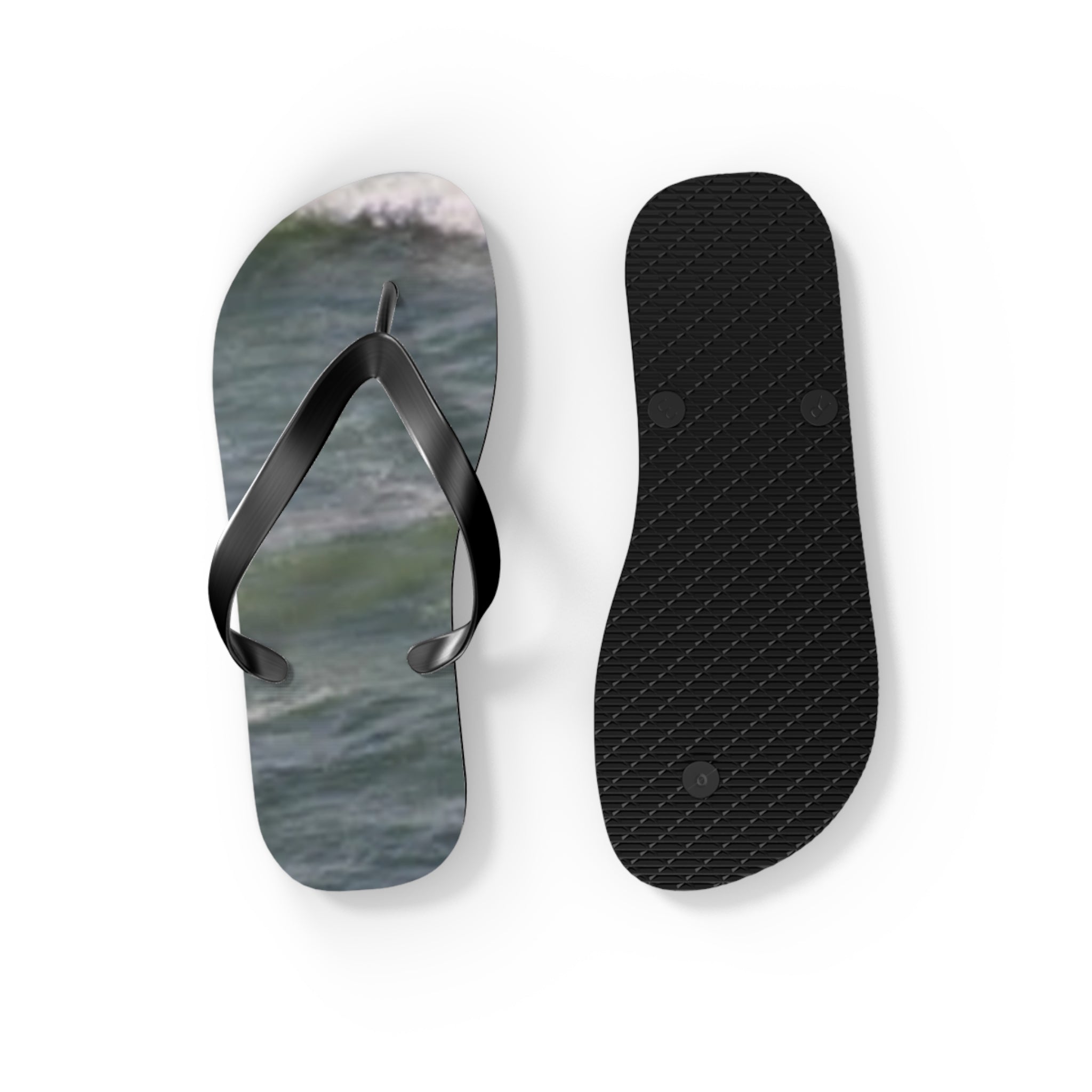 Flip-flops with ocean wave print on one sole and textured black sole on the other.