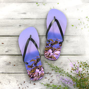 Purple flip-flops with a seaside nature scene printed on soles.