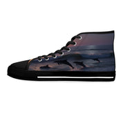High-top sneakers with leaping dolphins at sunset on a white background.