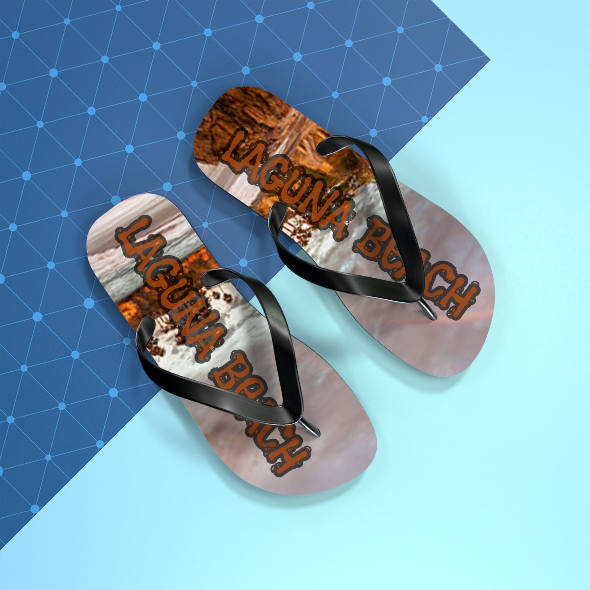 Laguna Beach flip flops with palm leaf pattern on blue geometric background.