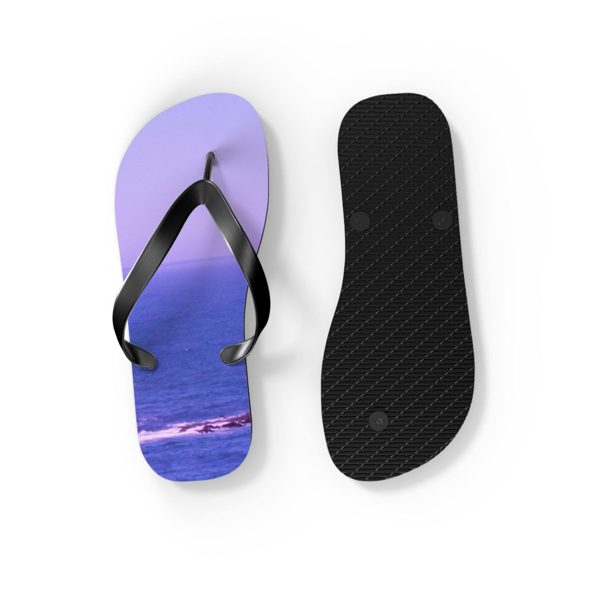 Flip-flops with a seascape design on the soles, isolated on white.