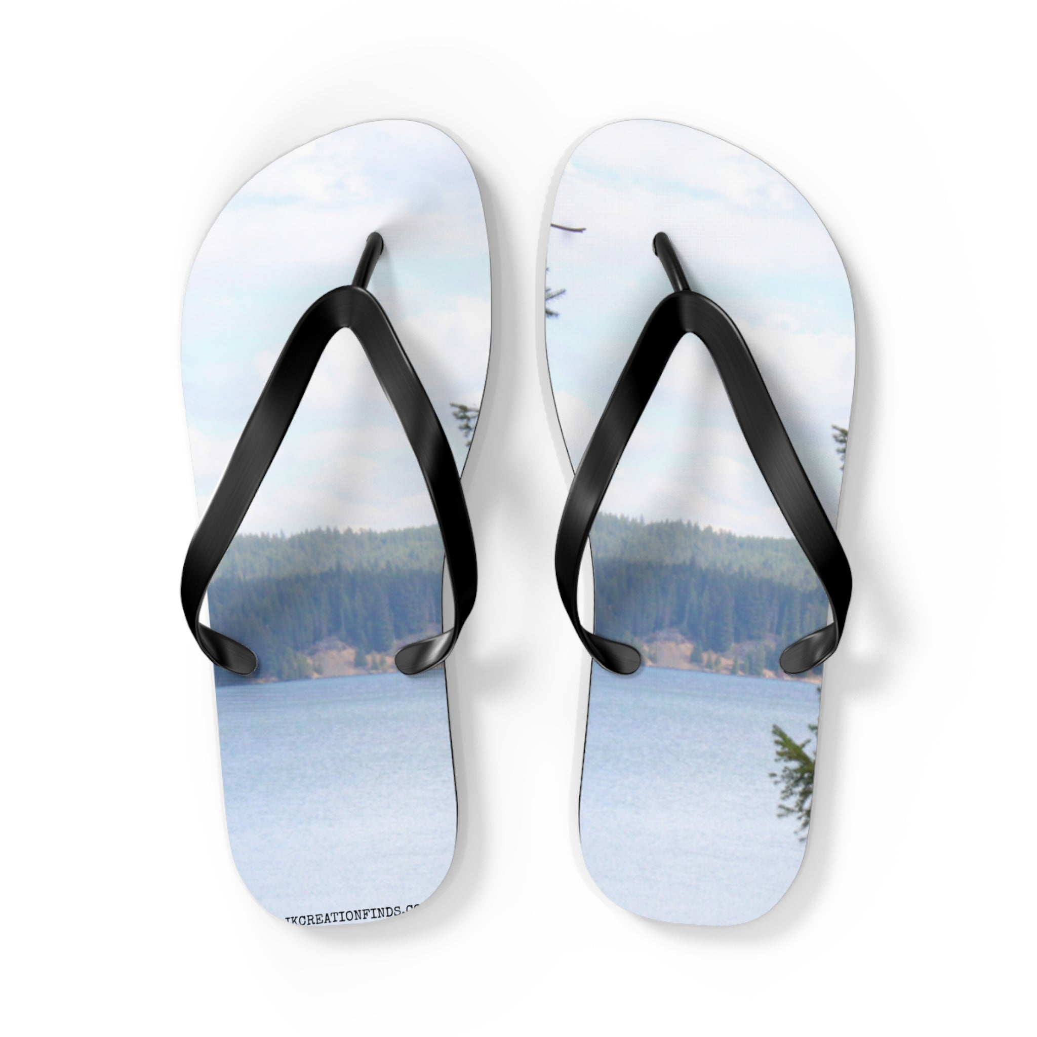 Flip-flops with a serene lake and forest landscape printed on the soles.