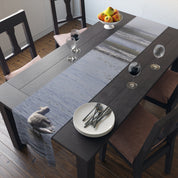 Table runner with a close-up of a swan on water and beach waves.