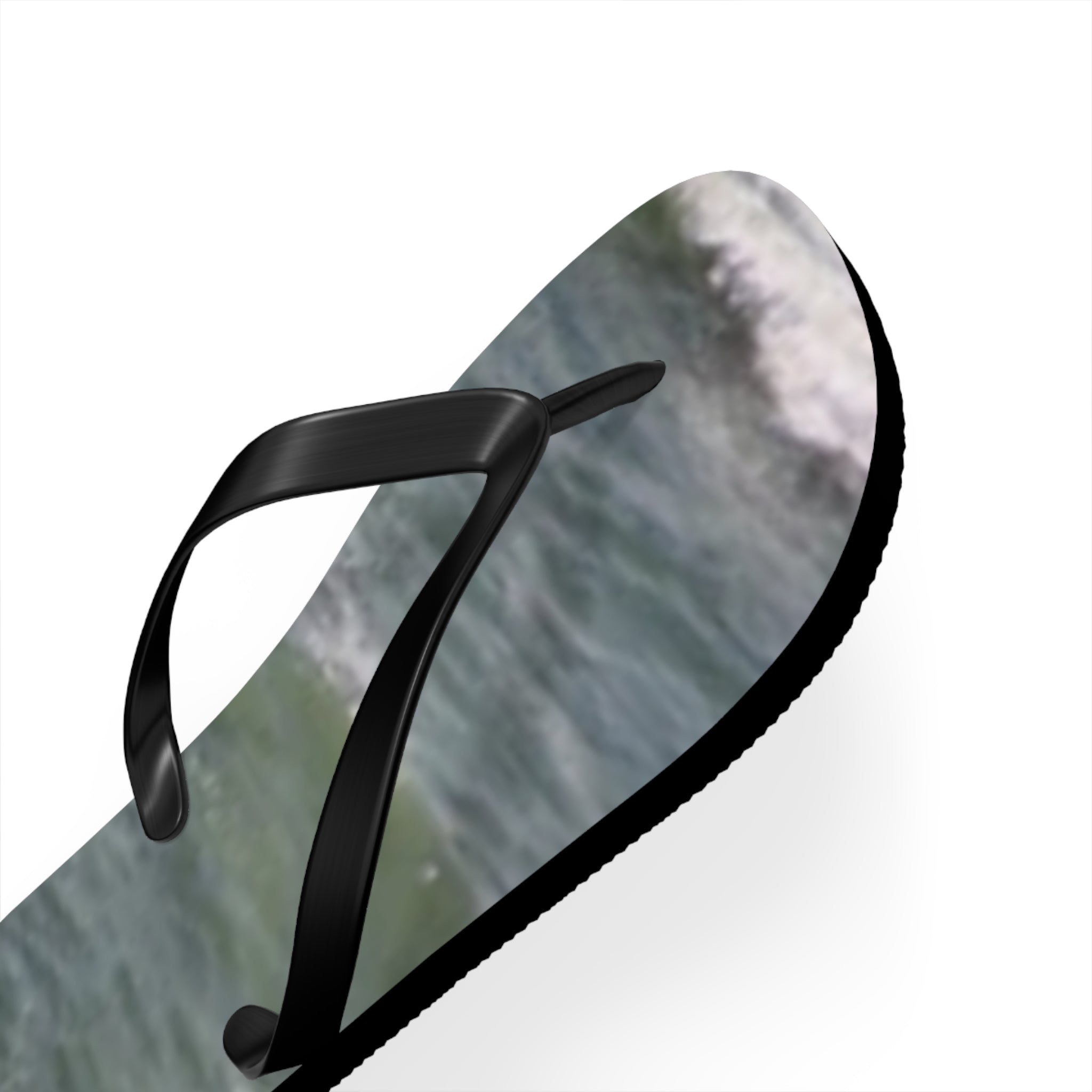 Black flip-flop with ocean wave pattern on the sole.