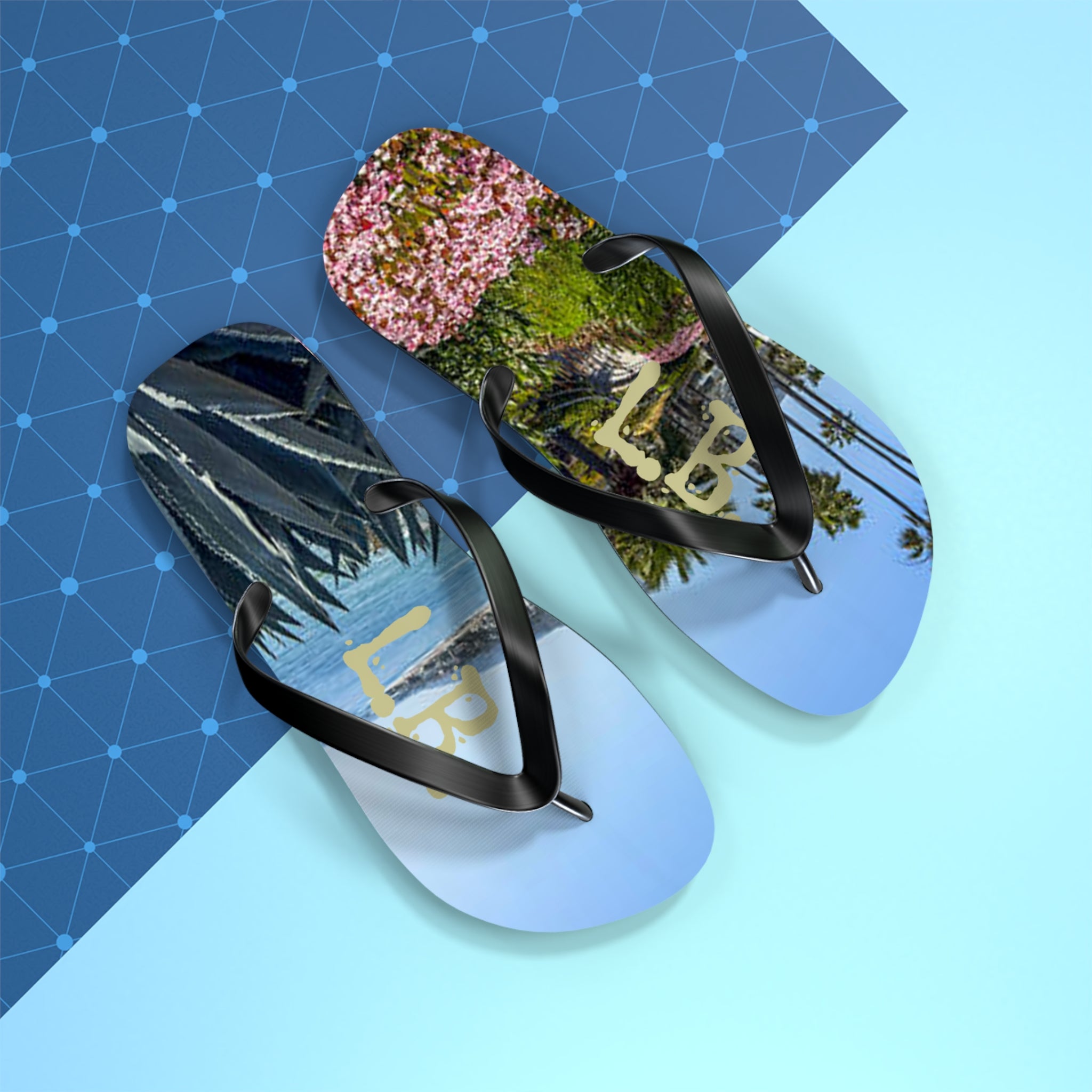 Flip-flops with "LB" logo and tropical scenery of palm trees and plants.