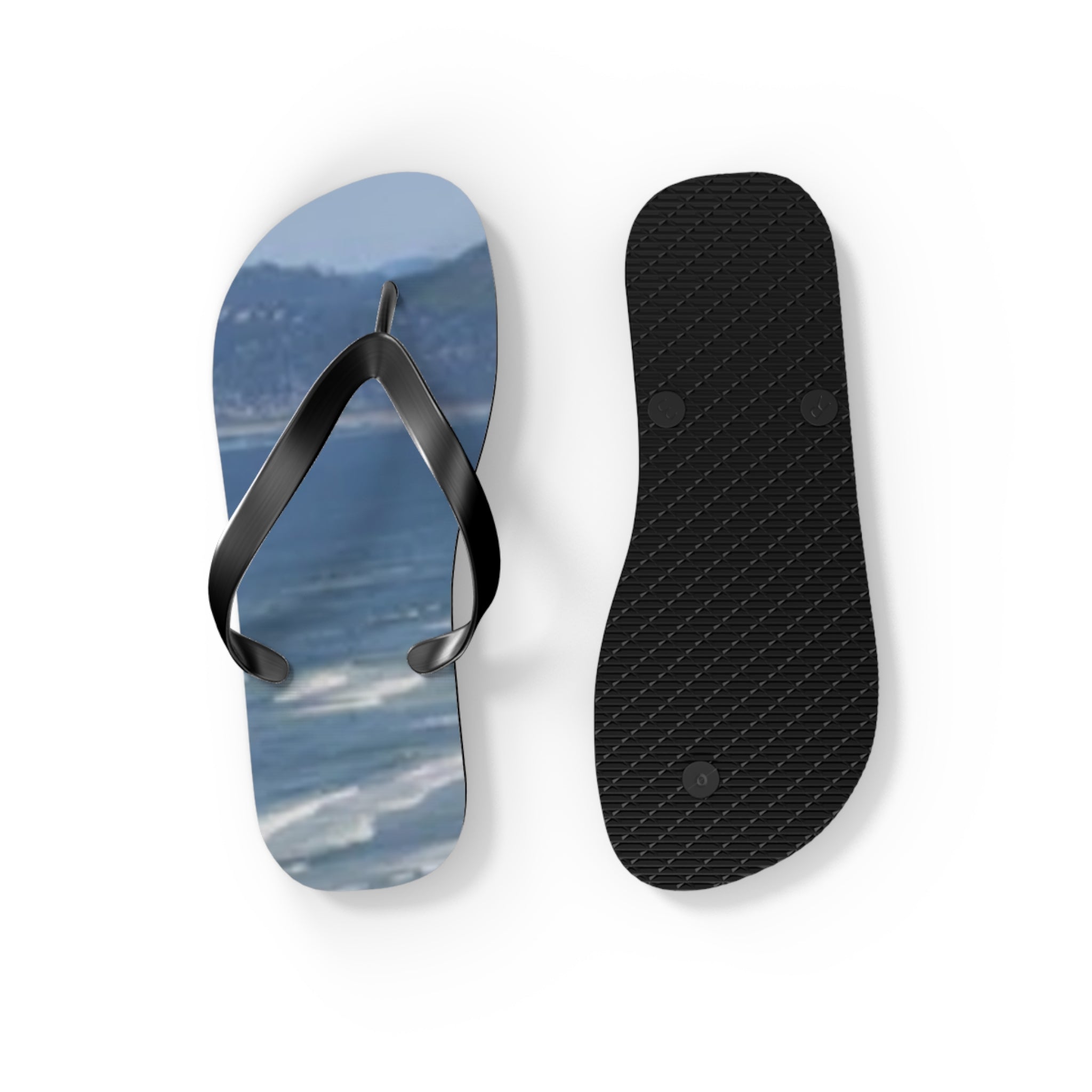 Flip-flops with a beach scene on the soles and a textured rubber bottom.