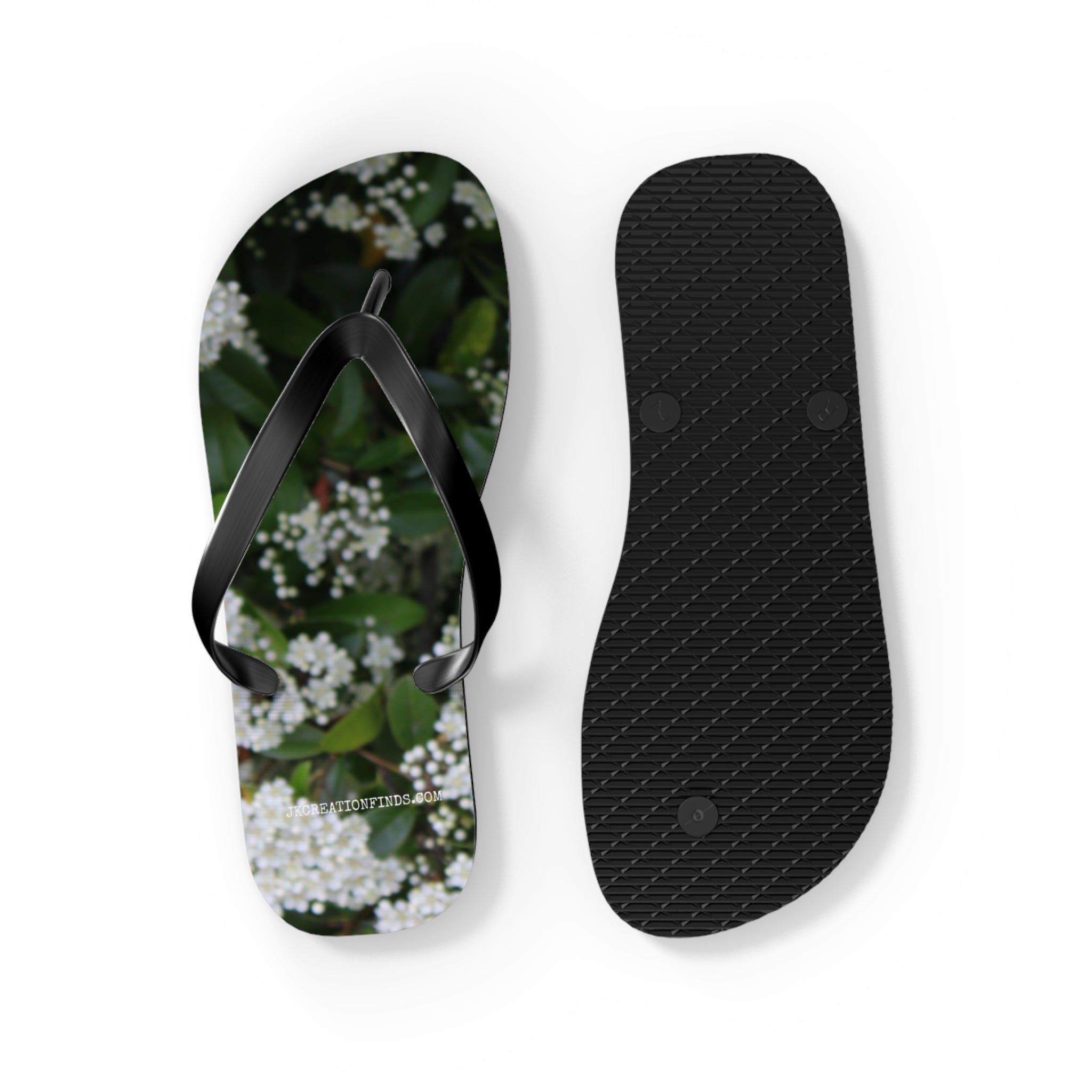 Flip-flops with a floral pattern and a black sole.