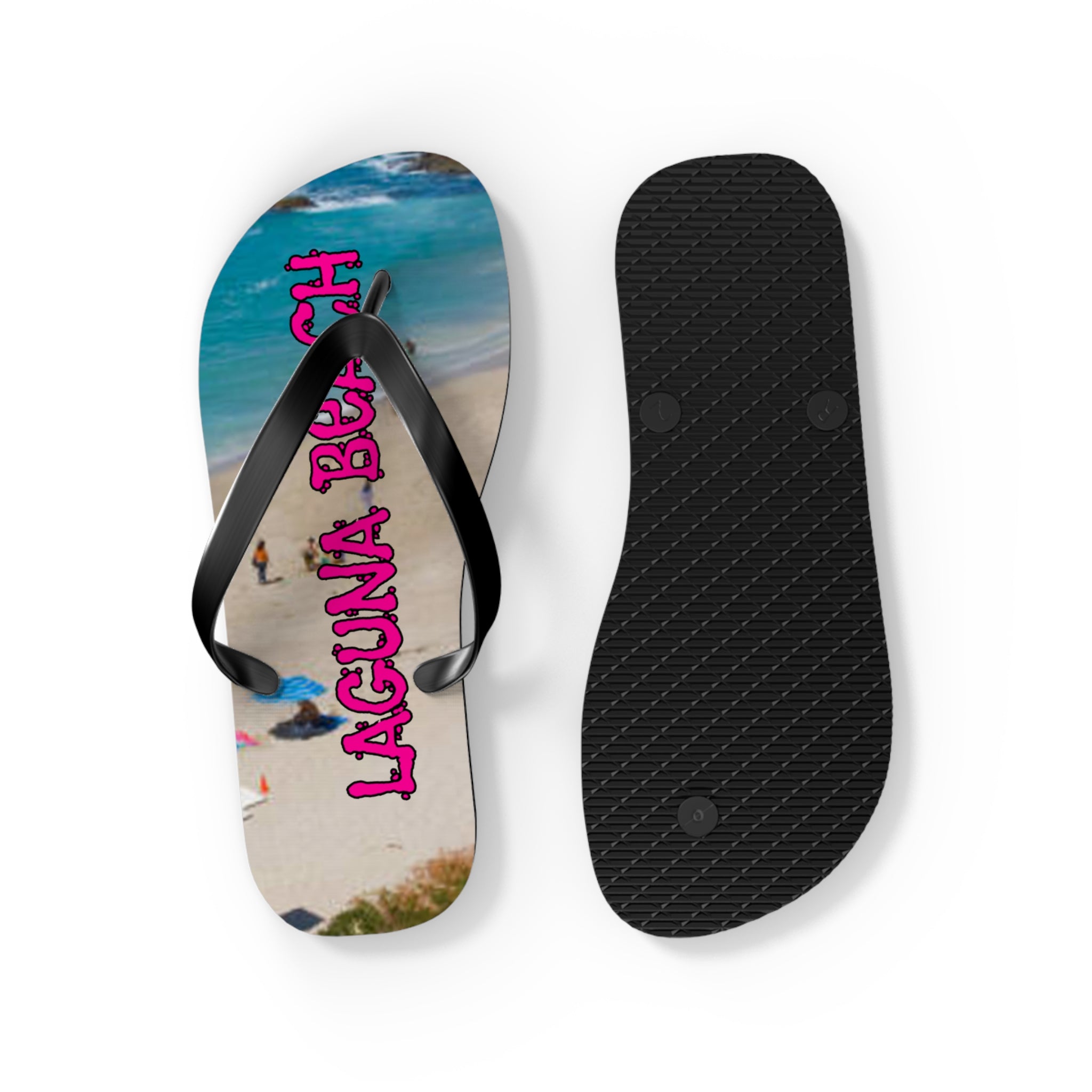 Black flip-flops with pink "LAGUNA BEACH" text on one sole.