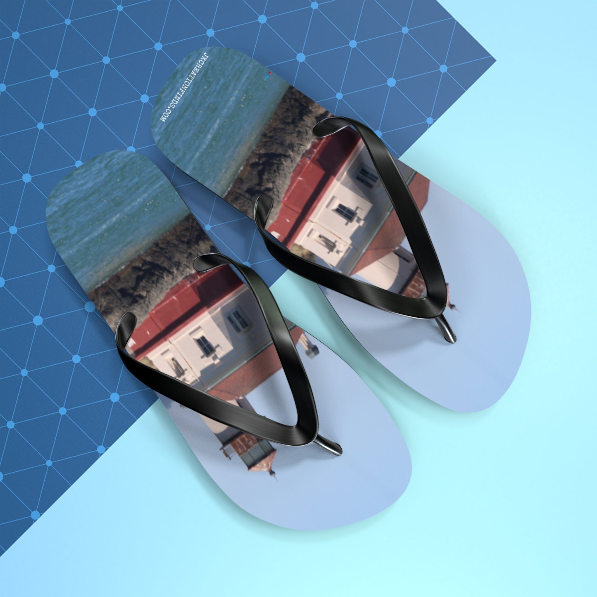 Flip flops featuring a lighthouse and ocean scene with a blue grid pattern.