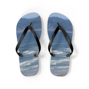 Flip-flops with a seascape and beach scene printed on the soles.
