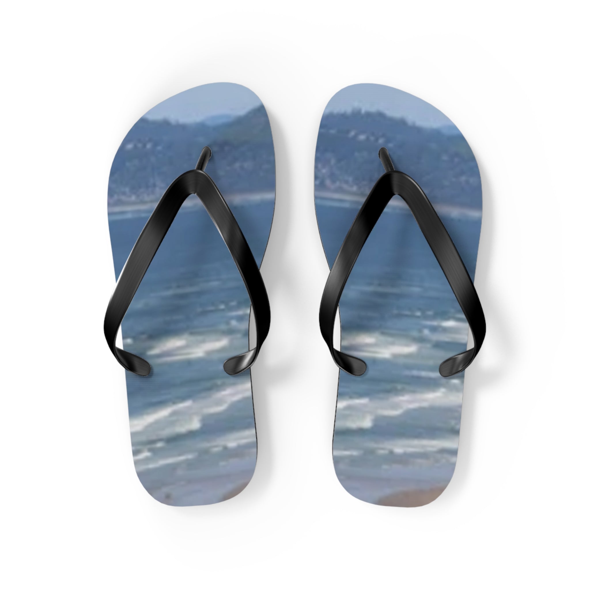 Flip-flops with a seascape and beach scene printed on the soles.