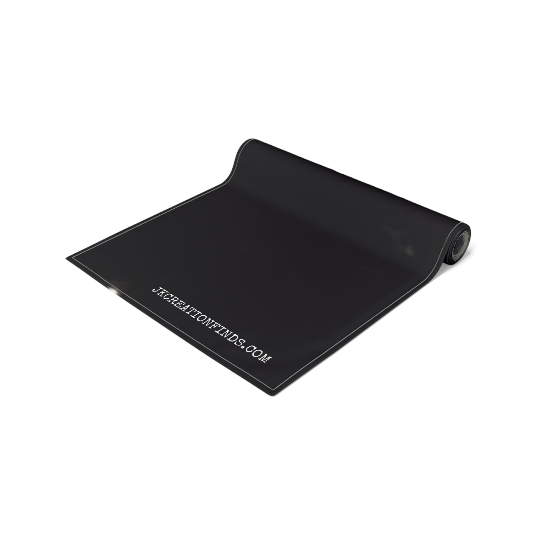 Black yoga mat with "JKCREATIONFINDS.COM" printed in white.