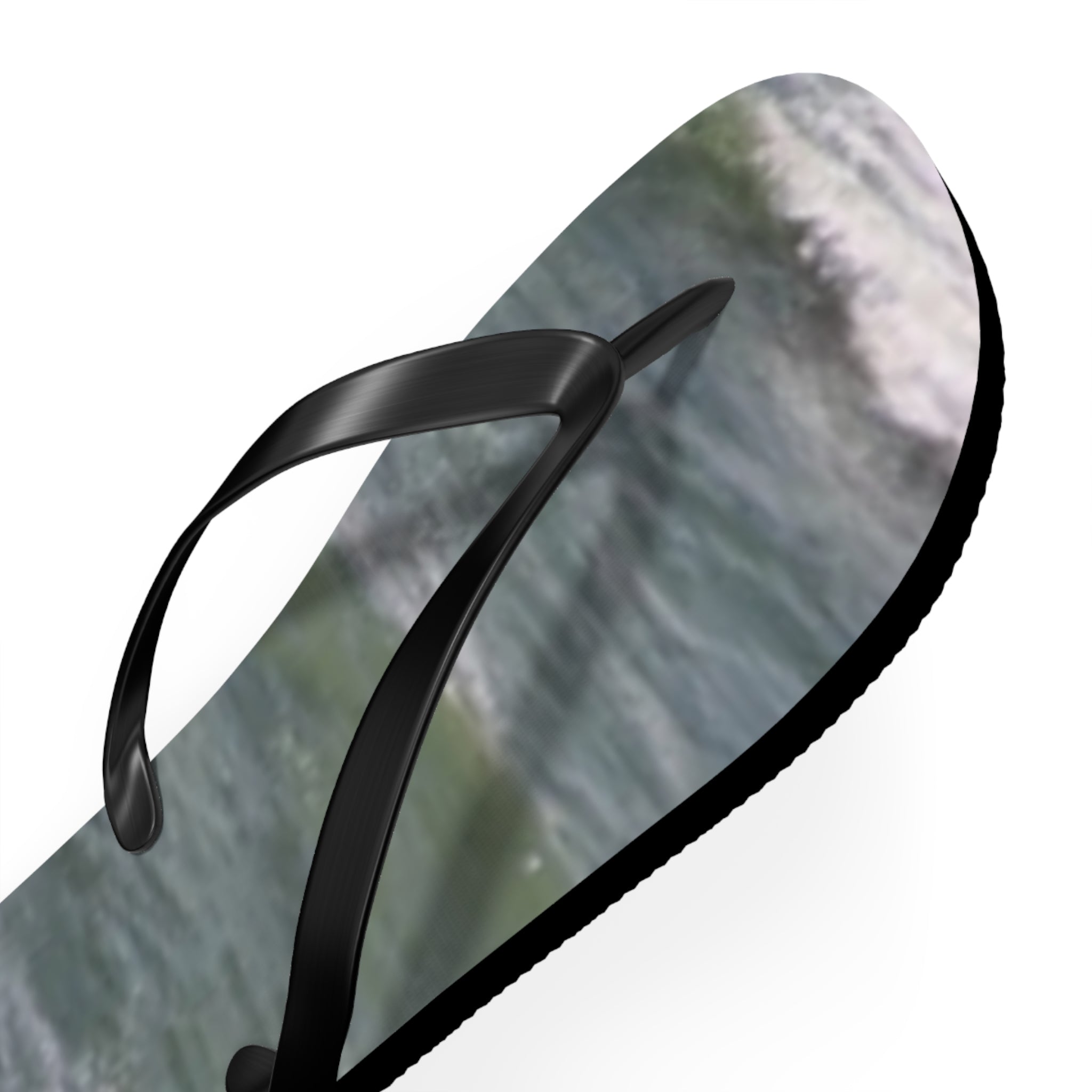 Black flip-flop with ocean wave design on the sole.